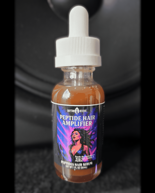 A small amber bottle of Rhythm & Revive Peptide Hair Amplifier serum with a dropper cap, featuring a label that shows a stylized woman with flowing hair against a purple and blue background.