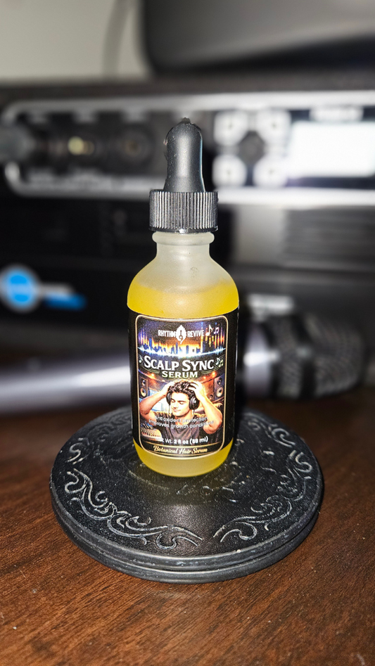 Rhythm and Revive's Scalp Sync Serum sitting on a desk near a microphone and music interface