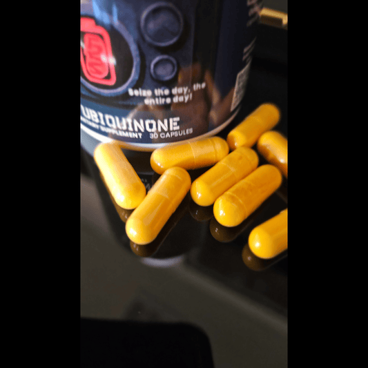 A close-up of a ubiquinone supplement bottle labeled ‘Ubiquinone Supplement 30 Capsules’ with several yellow capsules scattered on a reflective surface.