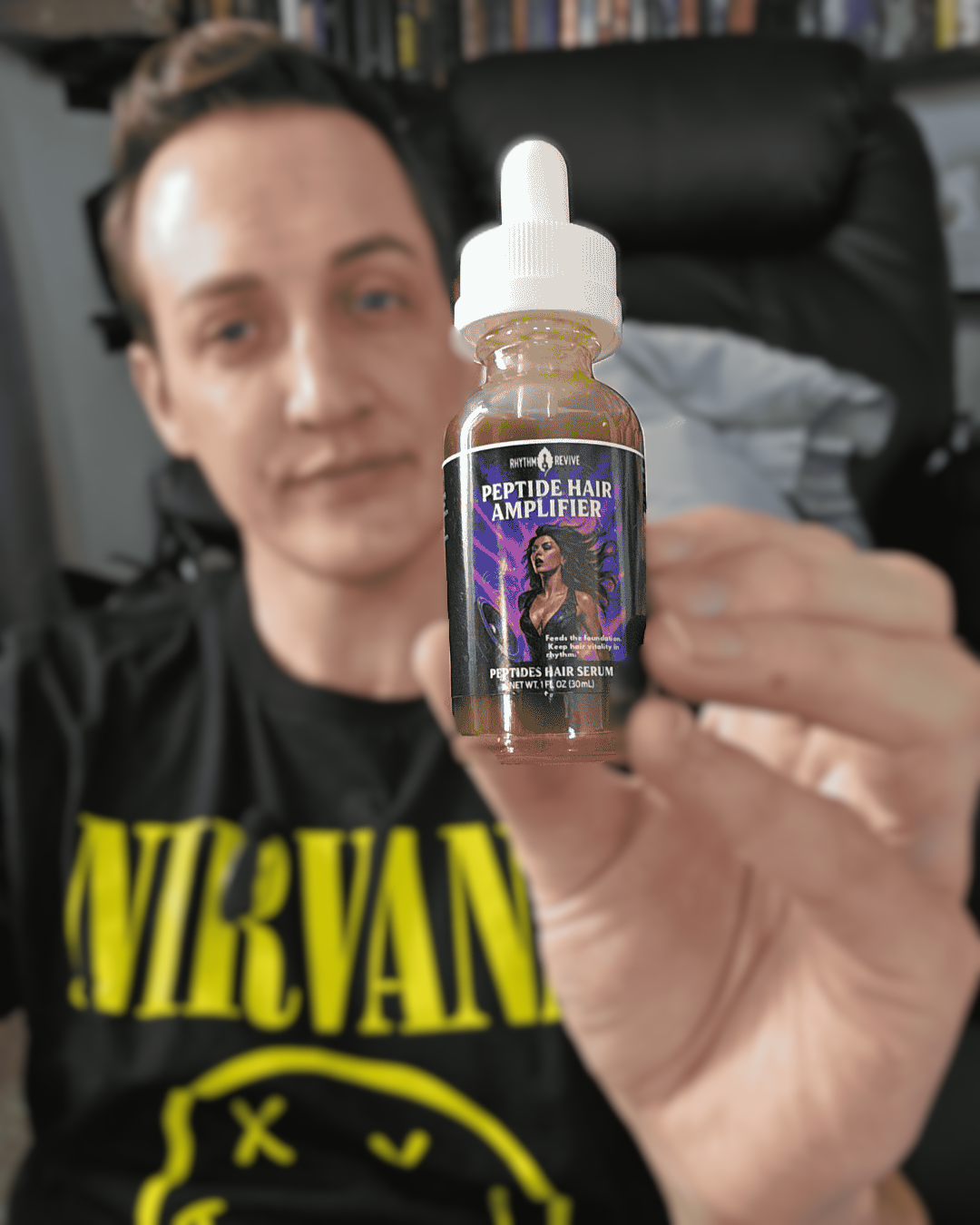 Person holding a bottle labeled 'Peptide Hair Amplifier' in front of a bookshelf.