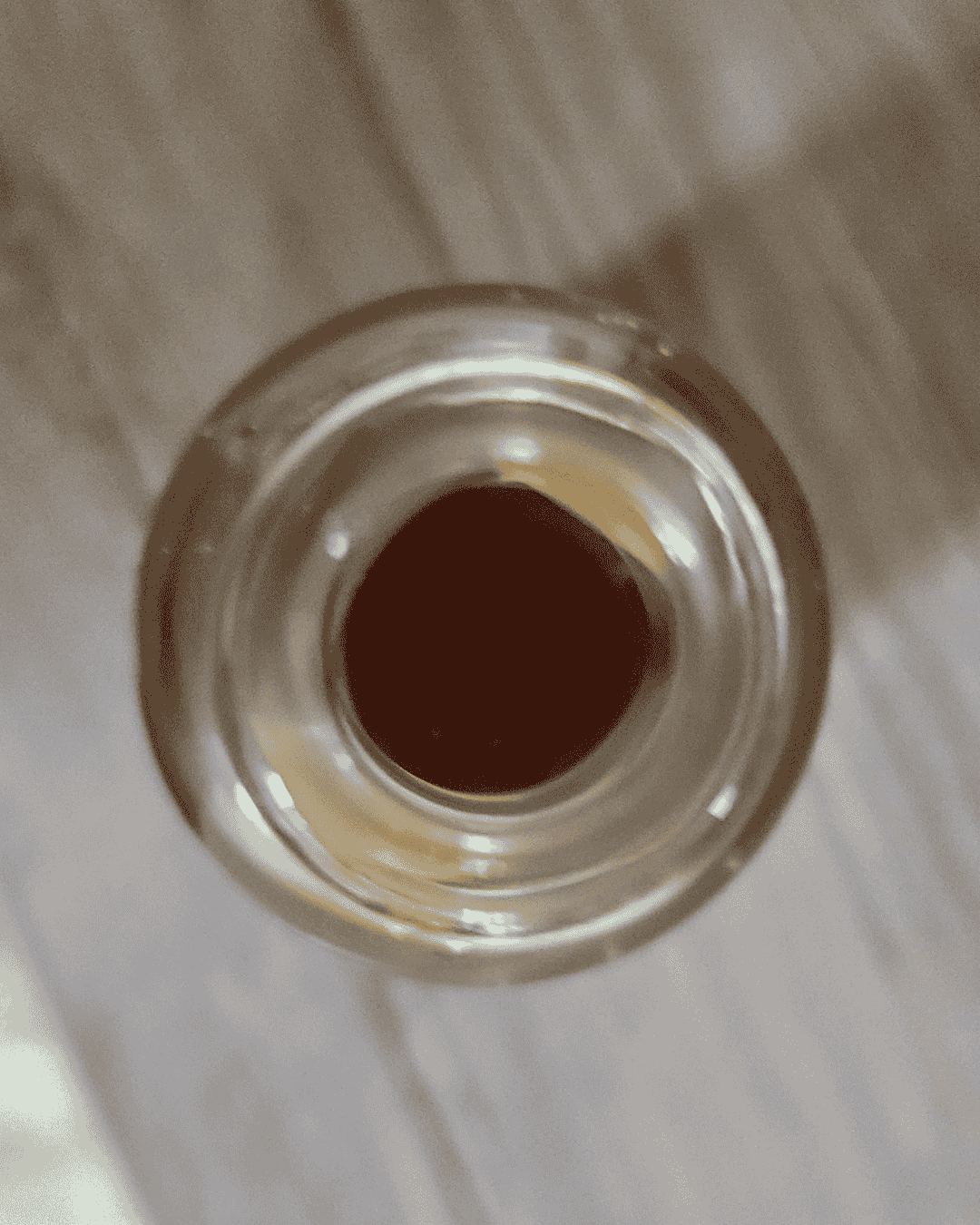 Close-up of a metallic object with a central hole on a light background