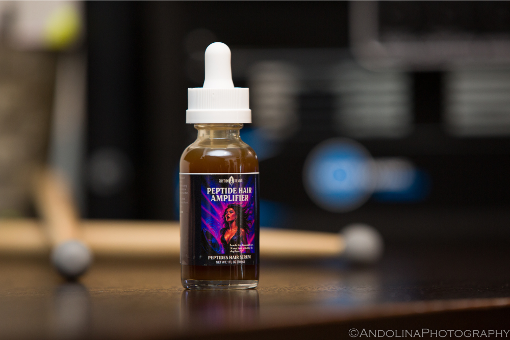 Bottle of Peptide Hair Amplifier on a wooden surface with a blurred background