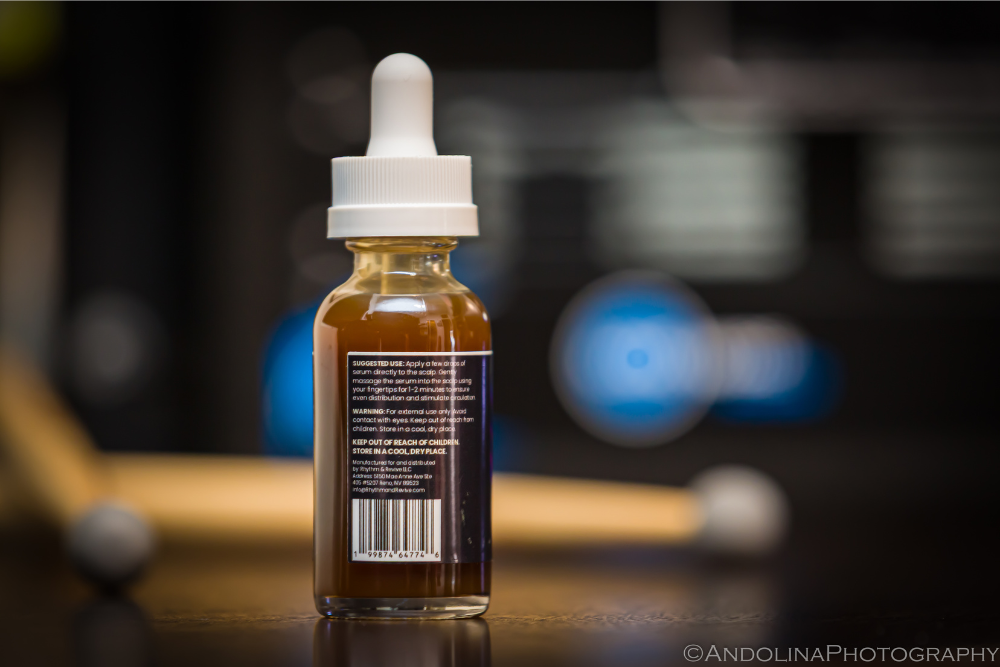 Bottle of liquid with a dropper on a blurred background