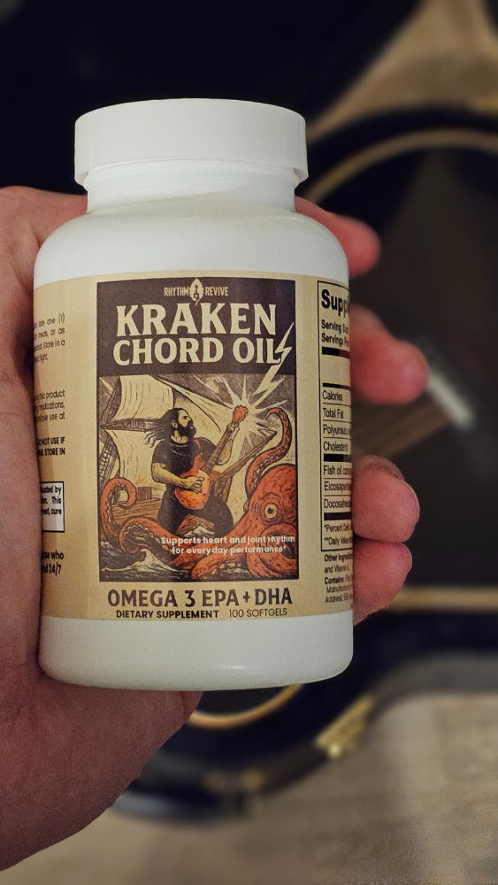 Hand holding a bottle of Kraken Chord Oil supplement with a blurred background