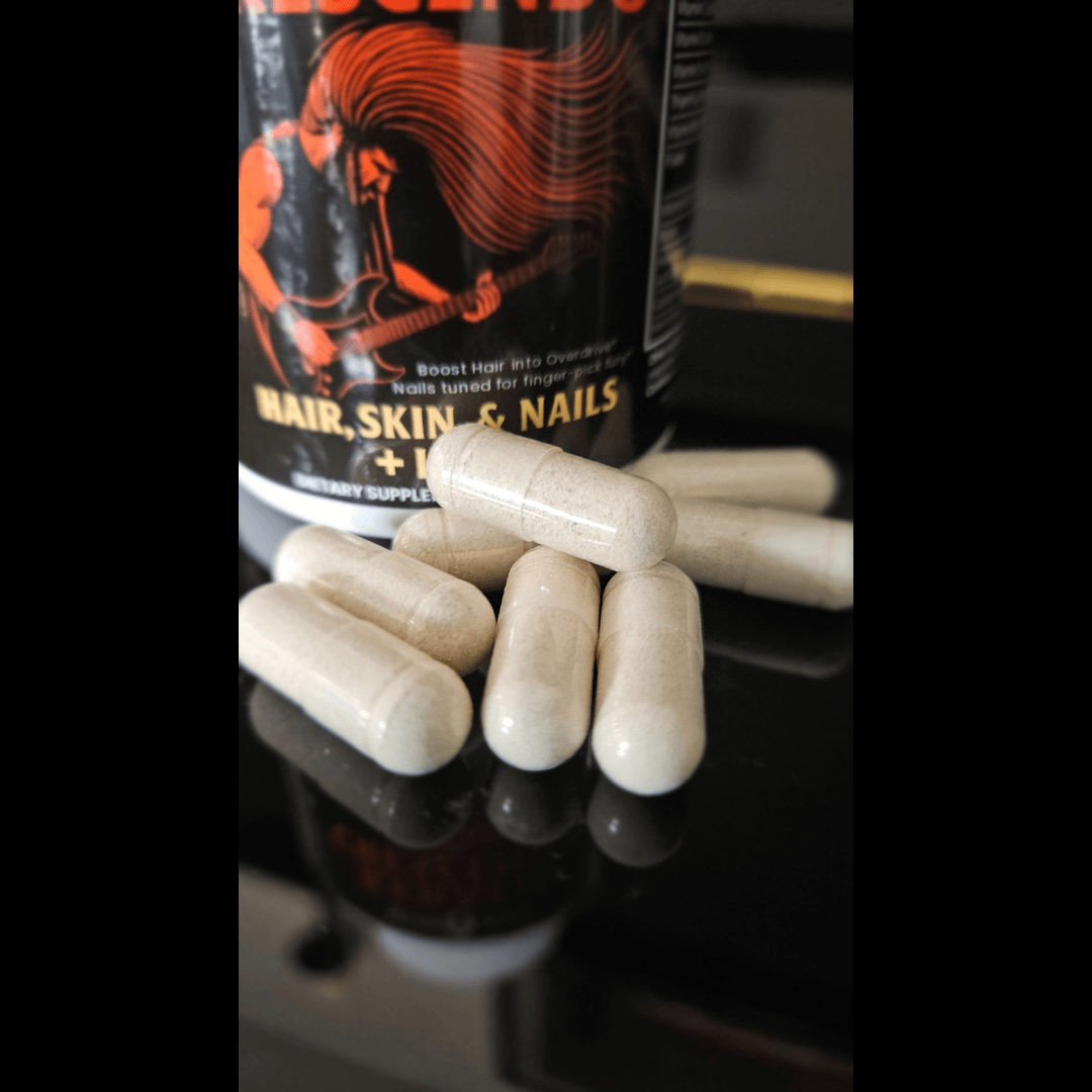 Supplement bottle labeled 'Hair, Skin & Nails' with capsules on a reflective surface