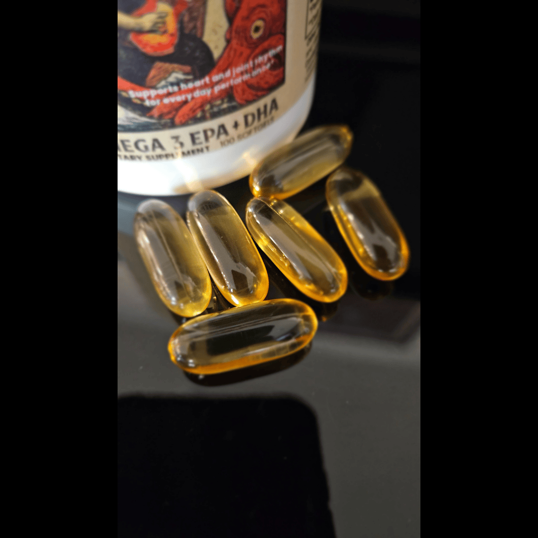 Omega 3 supplement capsules with a bottle labeled 'EPA + DHA' on a dark surface.
