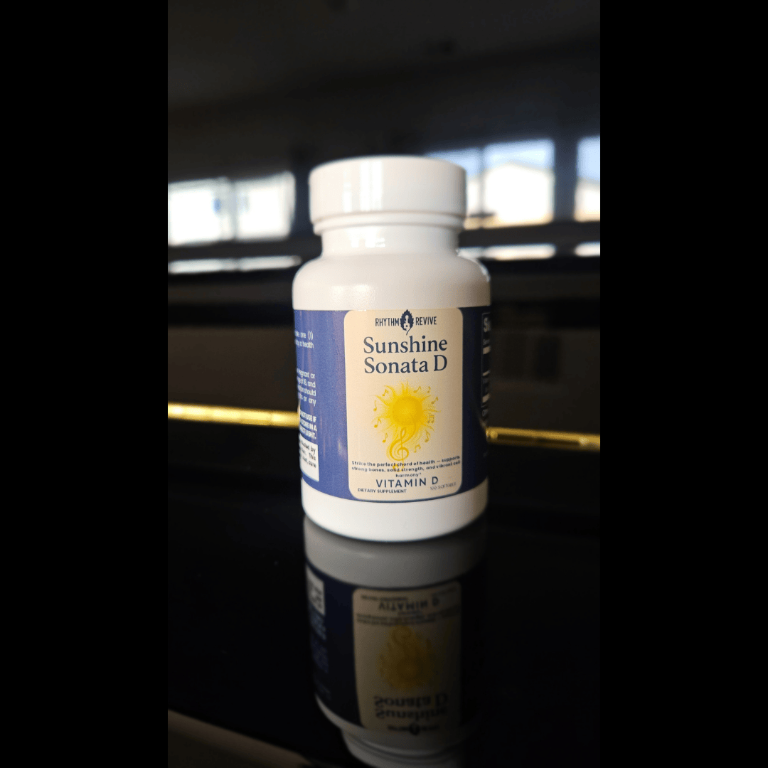 Bottle of Sunshine Sonata D Vitamin D supplement on a reflective surface with a blurred background.