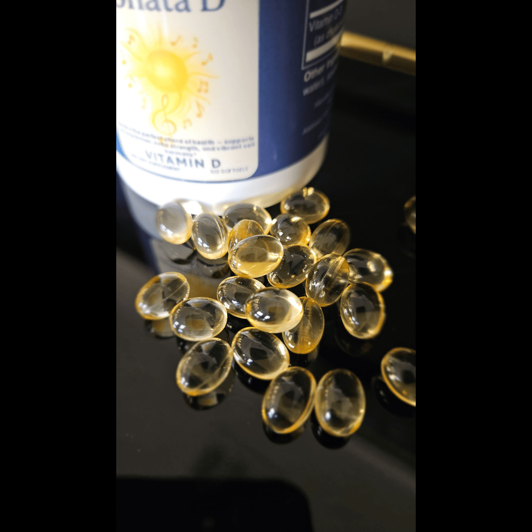 Vitamin D capsules and bottle on a reflective surface